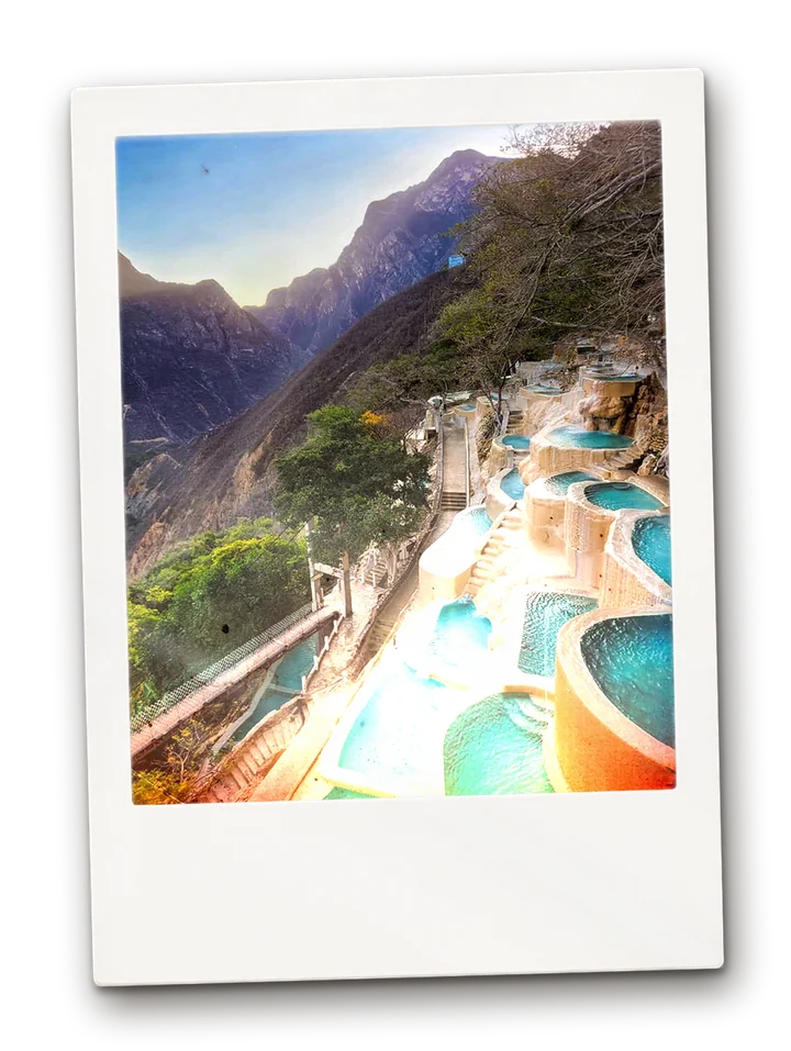 Turquoise hot-spring pools stepping down a canyon wall at Grutas de Tolantongo